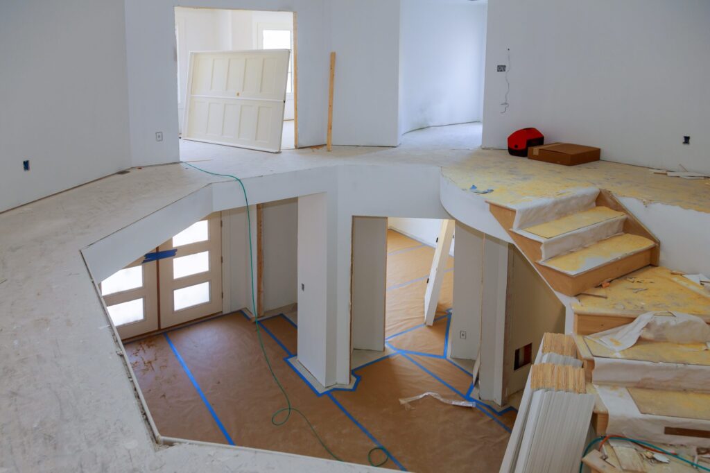 Home interior under construction with staircase.